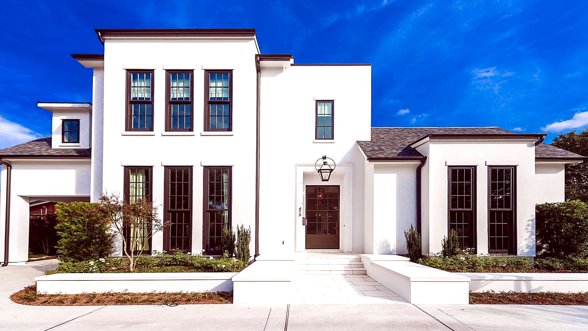 Luxury white home with shingle roof